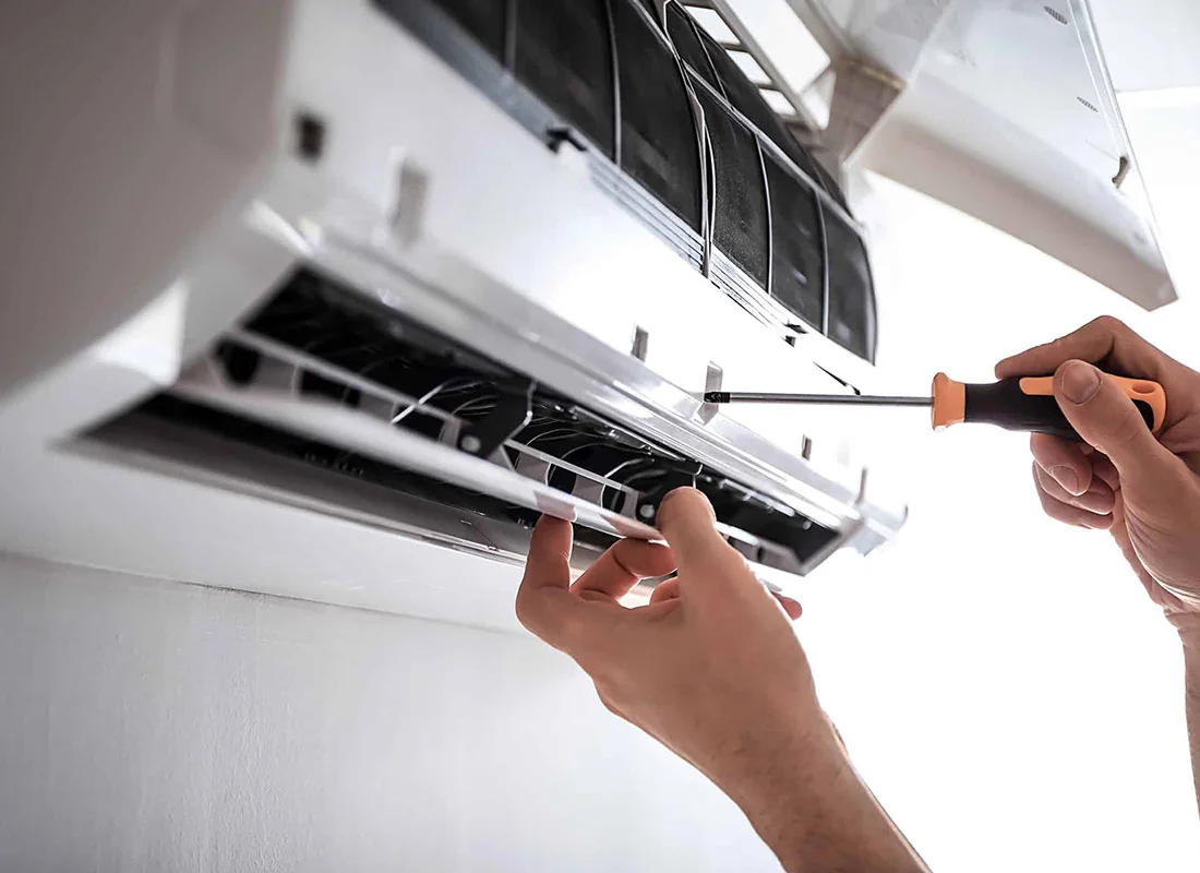 Close-up of a technician model servicing a ductless air conditioning unit