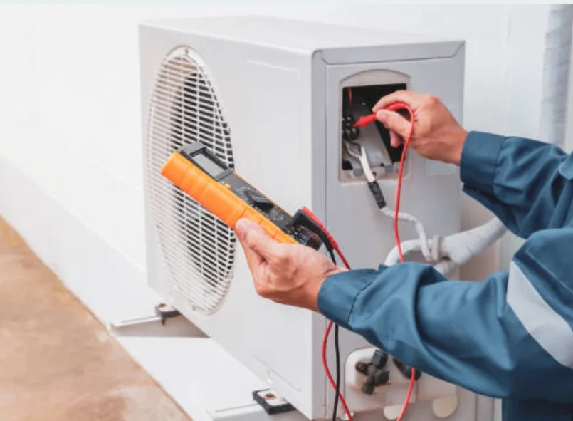 Technician model testing a residential outdoor HVAC unit with a multimeter