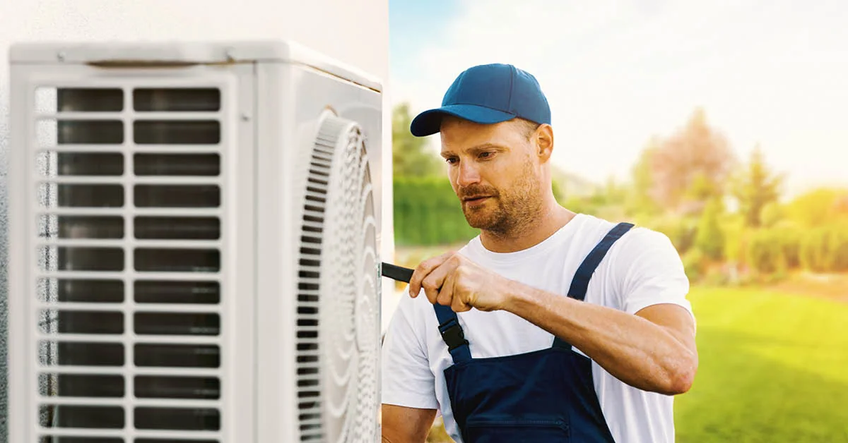 Technician model inspecting residential outdoor air conditioning equipment